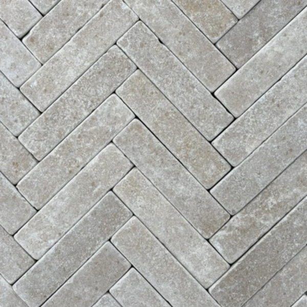Grey rectangular pavers laid in a herringbone pattern.
