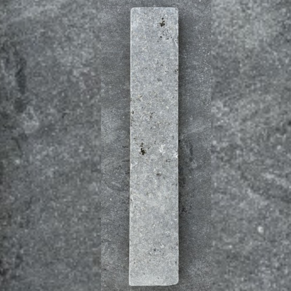 Light grey concrete paving strip with subtle surface texture, shown vertically on dark background